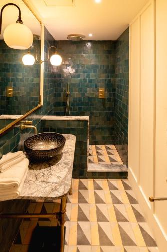 a bathroom with a sink and a mirror at The Mayson in Dublin
