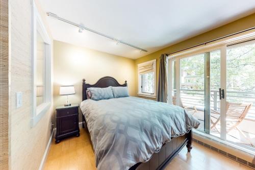 a bedroom with a bed and a large window at Happy Thoughts in Telluride