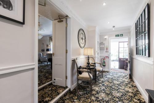 a hallway with a chair and a desk in a room at The Mount Pleasant Hotel in Sidmouth
