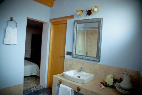 a bathroom with a sink and a mirror at Casa La Remolina in Casas Ibáñez