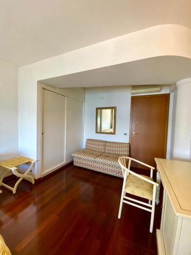 a living room with a bed and a table at Camere Al Veliero in Gardone Riviera