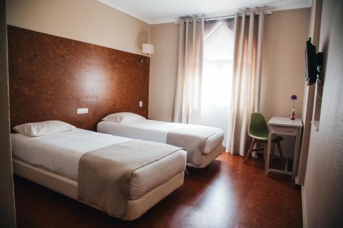 Кровать или кровати в номере Hotel Laitau