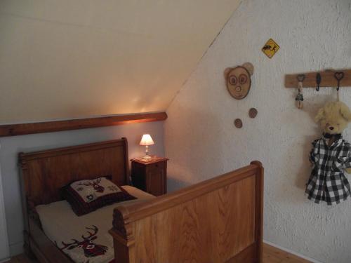 a bedroom with a bed and a teddy bear on the wall at chambres du grès rouge de Beauval in Beauval