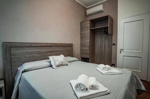 a bedroom with a bed with towels on it at Angelica Home in Mestre