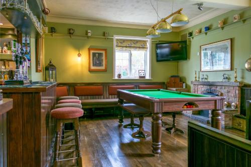 a pub with a pool table and a bar at The Fleece Inn in Bishop Wilton