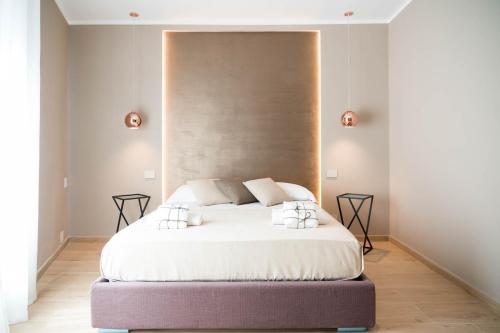 En eller flere senge i et værelse på Teseo Rooms & Relax