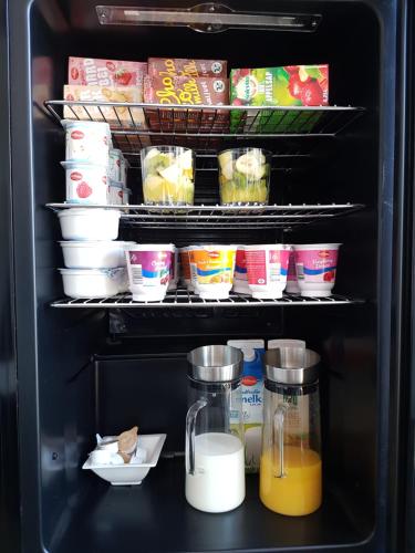 an open refrigerator filled with food and drinks at ANNO 1919 in Swalmen