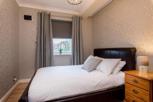 a bedroom with a large bed and a window at Cattle Market View Apartment in Boston