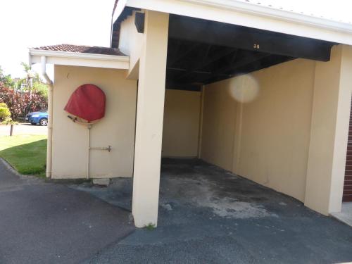 a building with a garage with a red door at Sole's Leap in Scottburgh