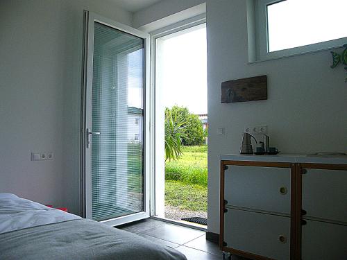 a bedroom with a bed and a sliding glass door at Scherer Living in Engabrunn