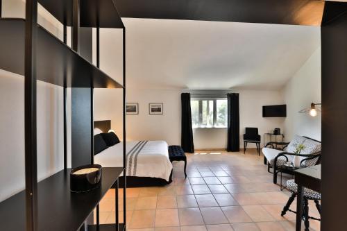 a hotel room with a bed and a desk at Quintessence Provence in Goult