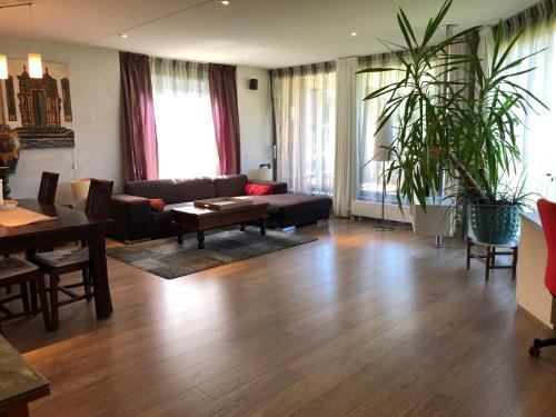 a living room with a couch and a table at Lounge Park Apartment in Amsterdam