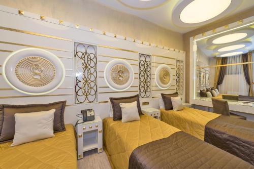a bedroom with two beds and a mirror at The Million Stone Hotel - Special Category in Istanbul