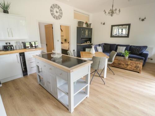 a kitchen and living room with a counter top at The Barn in Redditch