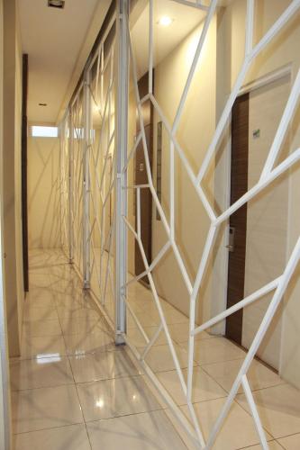 a hallway in a building with a glass wall at The Peak Guest House in Jember