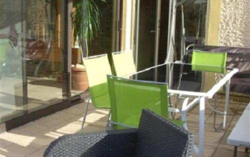 a group of chairs and tables on a patio at Le Valhento in Bouillon