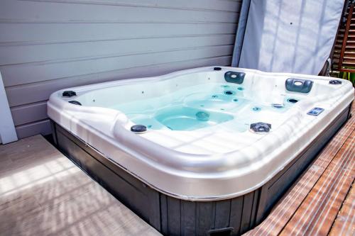 a jacuzzi tub sitting on a deck at EDEN FOREST Villas in Pointe-Noire