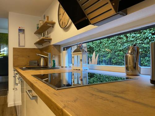 a kitchen with a counter with a sink and a window at Ferienwohnung Katharina 4 Sterne laut DTV Wallbox 11KW in Nideggen