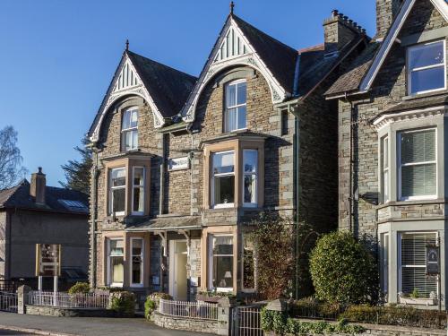 a brick house with a black roof at Elder Grove in Ambleside