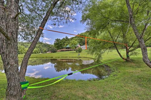 a rope tied to a tree next to a lake at Pet-Friendly Cabin with Hot Tub in Daniel Boone NF in Beattyville