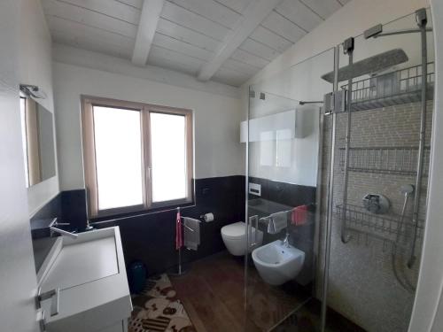 a bathroom with a toilet and a sink and a shower at Dro Suite in Dro