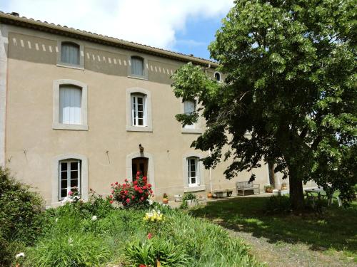 a large house with a tree in front of it at Domaine Saint-Louis in Carcassonne