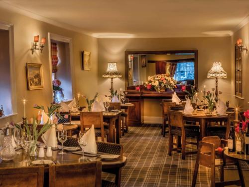 a restaurant with tables and chairs in a room at The Fauconberg in Coxwold