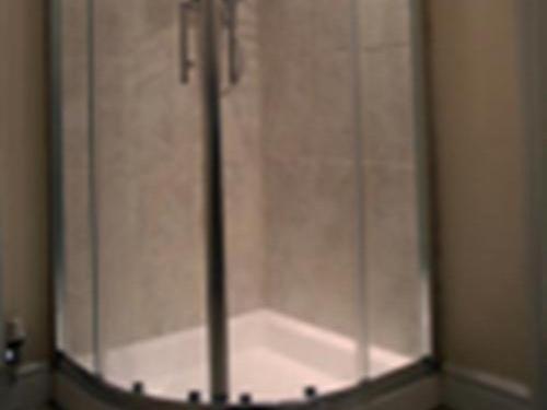 a glass door of a shower in a bathroom at Frome Dale in Wool