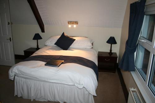 A bed or beds in a room at The Old School House Hotel 