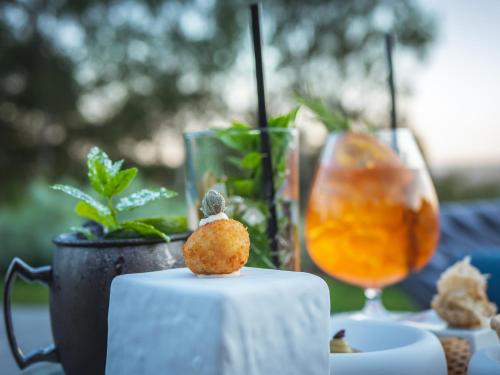 a piece of food sitting on a table with a drink at Phi Hotel Piajo in Nembro