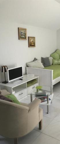 a living room with a bed and a desk and a couch at Apartment Klatenberg in Telgte