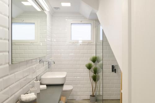 a white bathroom with a sink and a toilet at Buenavista Ocean View in Puerto del Carmen