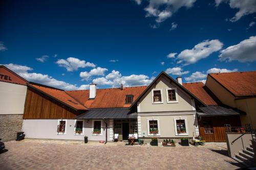 a large white house with red roofs at Penzion Šatlava in Nové Město nad Metují