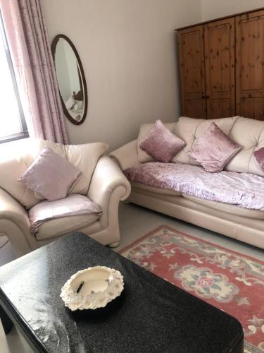 
a living room with a couch and a coffee table at Brown's Guest House in Peterhead
