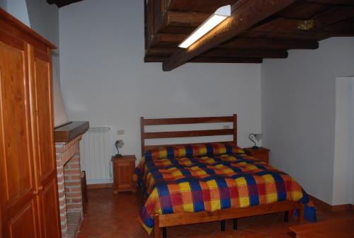 a bedroom with a bed with a colorful blanket at Le case all'arco in Castropignano