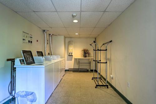 a room with a hallway with a counter and a table at Lake Getaway Walk Across Street to Private Beach! in Gilford