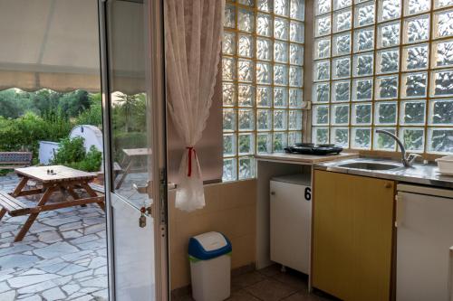 a kitchen with a view of a patio at Villa Gesthimani in Neos Marmaras