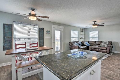 a kitchen and living room with a couch and a table at 2 Blocks to Gulf Surfside Beach Family Home! in Surfside Beach