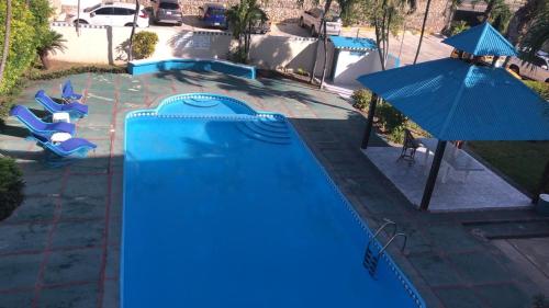 an overhead view of a swimming pool with an umbrella at La Gaviota B3 in Juan Dolio