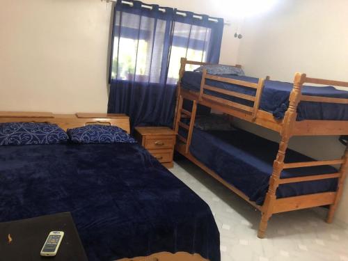 a bedroom with two bunk beds and a window at La Gaviota B3 in Juan Dolio