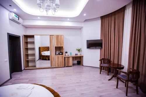 a hotel room with a bed and a mirror at Hotel Ak Saray in Tashkent