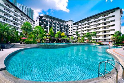 a large swimming pool in front of a hotel at Wongamat Privacy Residence, Pattaya in Pattaya North
