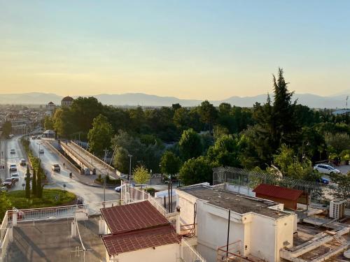 an aerial view of a city with mountains in the background at Ξενοδοχείο Acropol in Larisa