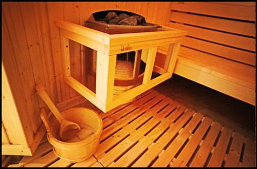 a wooden sauna with a toilet in a room at Atrium Agárd Panzió in Gárdony