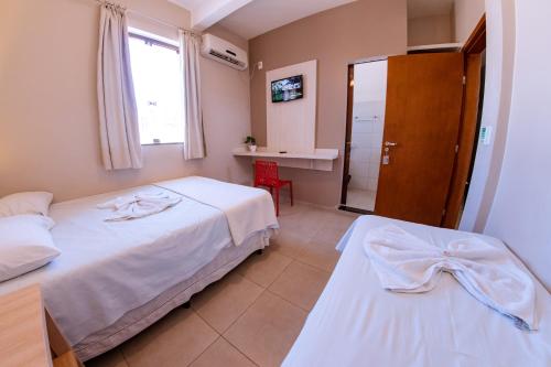 Postel nebo postele na pokoji v ubytování Hotel Ipiranga Maringa