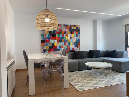 a living room with a couch and a table at Oktheway Pedro Saco Street in Sarria