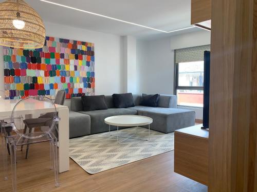 a living room with a couch and a table at Oktheway Pedro Saco Street in Sarria