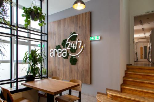 a restaurant with a table and a sign on the wall at area24|7 Europaplatz in Karlsruhe
