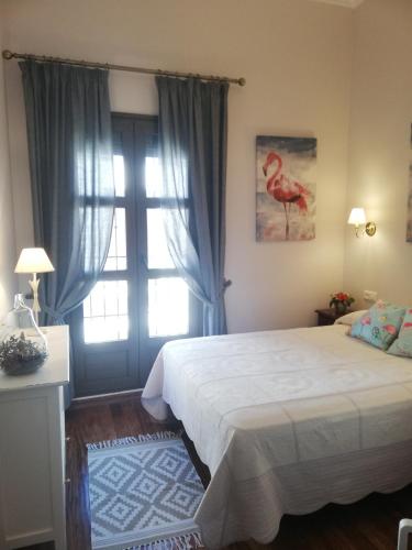 a bedroom with a large bed and a window at Casa Candela in Ronda