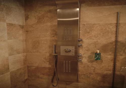a shower with a glass door in a bathroom at SEE Moment Appartements ADULTS ONLY in St. Wolfgang